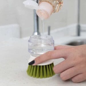 Relleno rápido del cepillo lavavajillas con dispensador – Práctico y eficiente Persona rellenando con detergente el cepillo lavavajillas Alemka con dosificador automático
